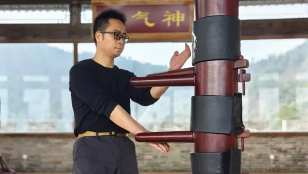 Wooden Dummy Techniques Wing Chun course cover image with Master Liu demonstrating wooden dummy applications and drills.